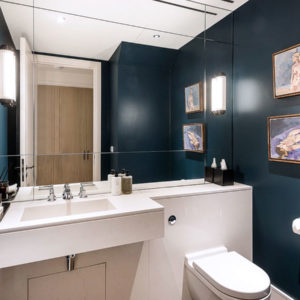 Bespoke quartz stone wash basin and cladding in a guest WC