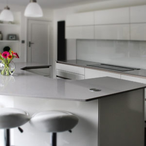 Angular kitchen island with grey quartz worktop